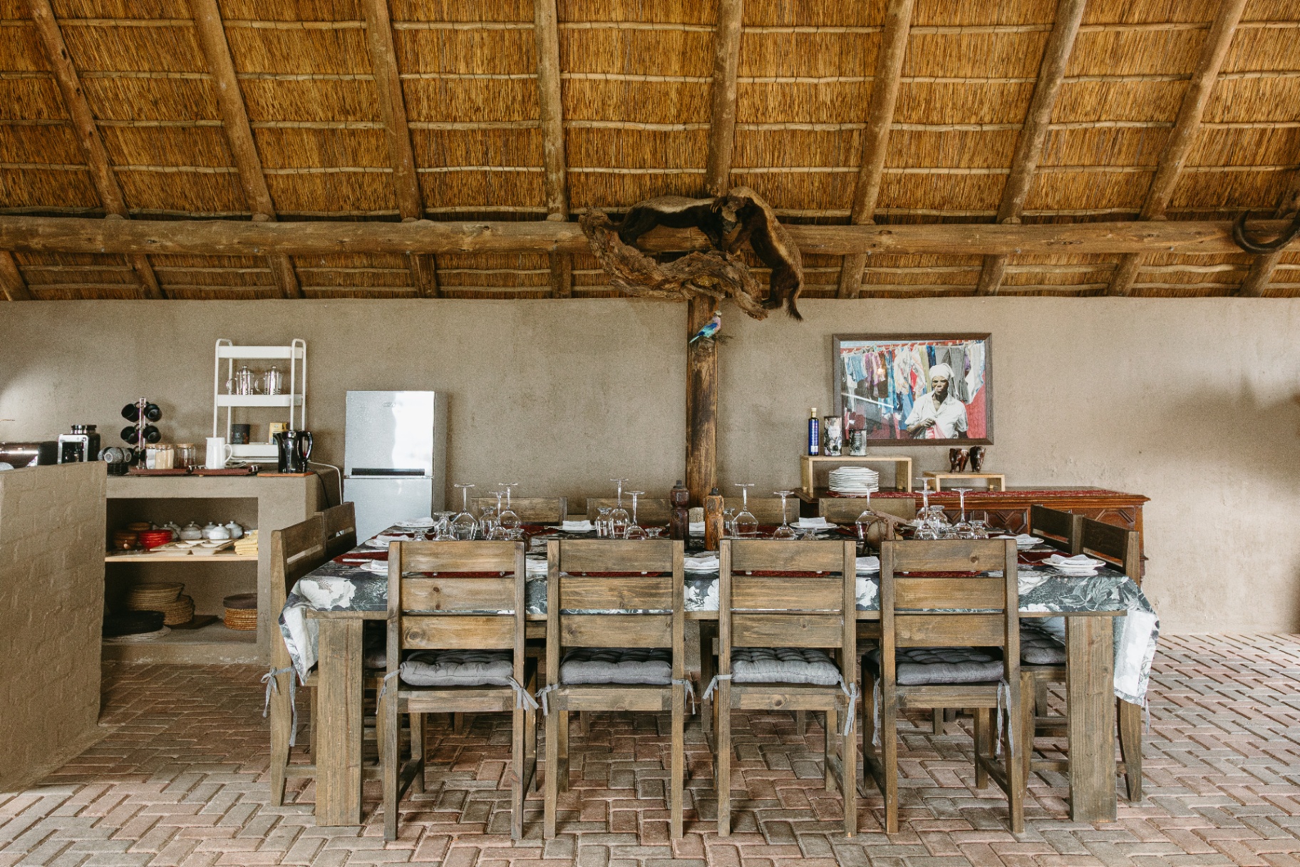 Long dining table set under thatch