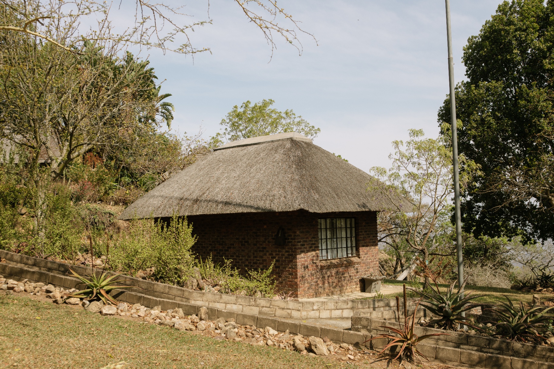 Thatched brick cottage on a stone terrace