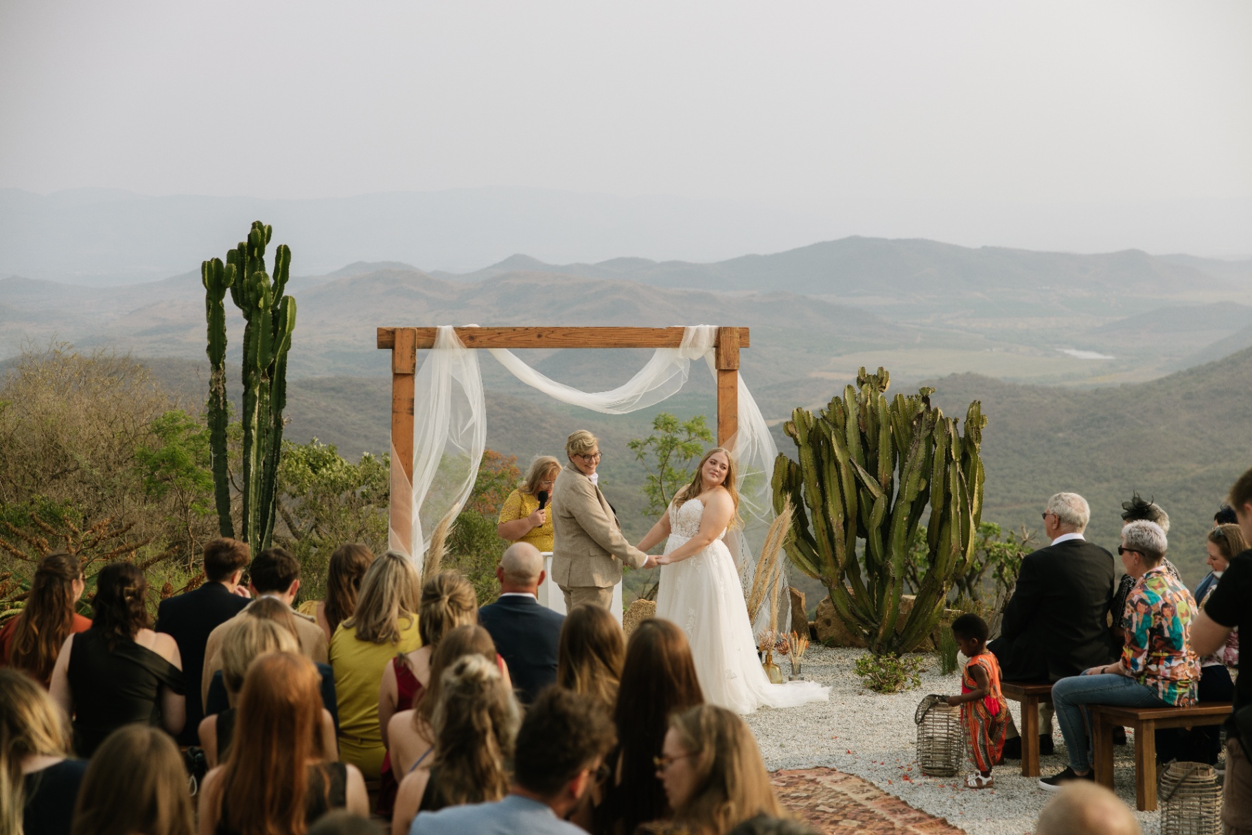 Bride and groom at the altar with the valley beyond