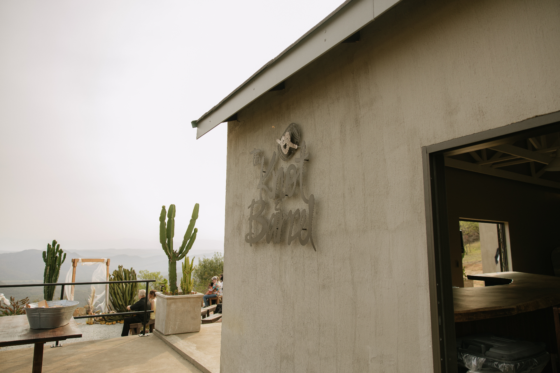 Venue exterior with the ceremony lawn and cactus planters beyond