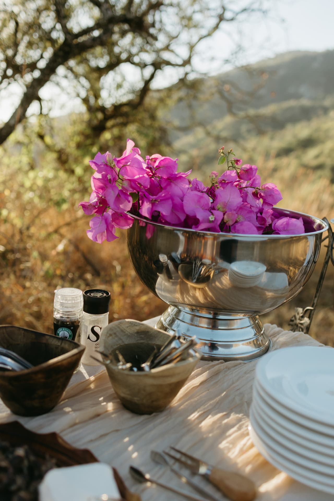 Silver bowl filled with pink bougainvillea blooms