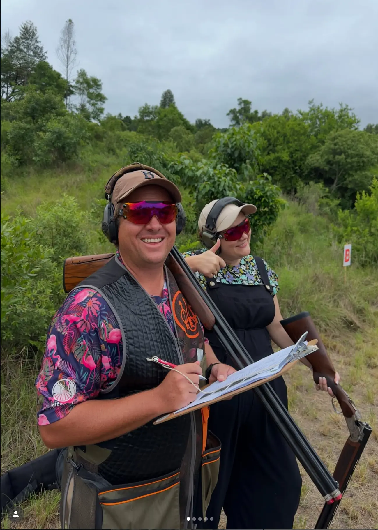 Two shooters filling in a scorecard between stands
