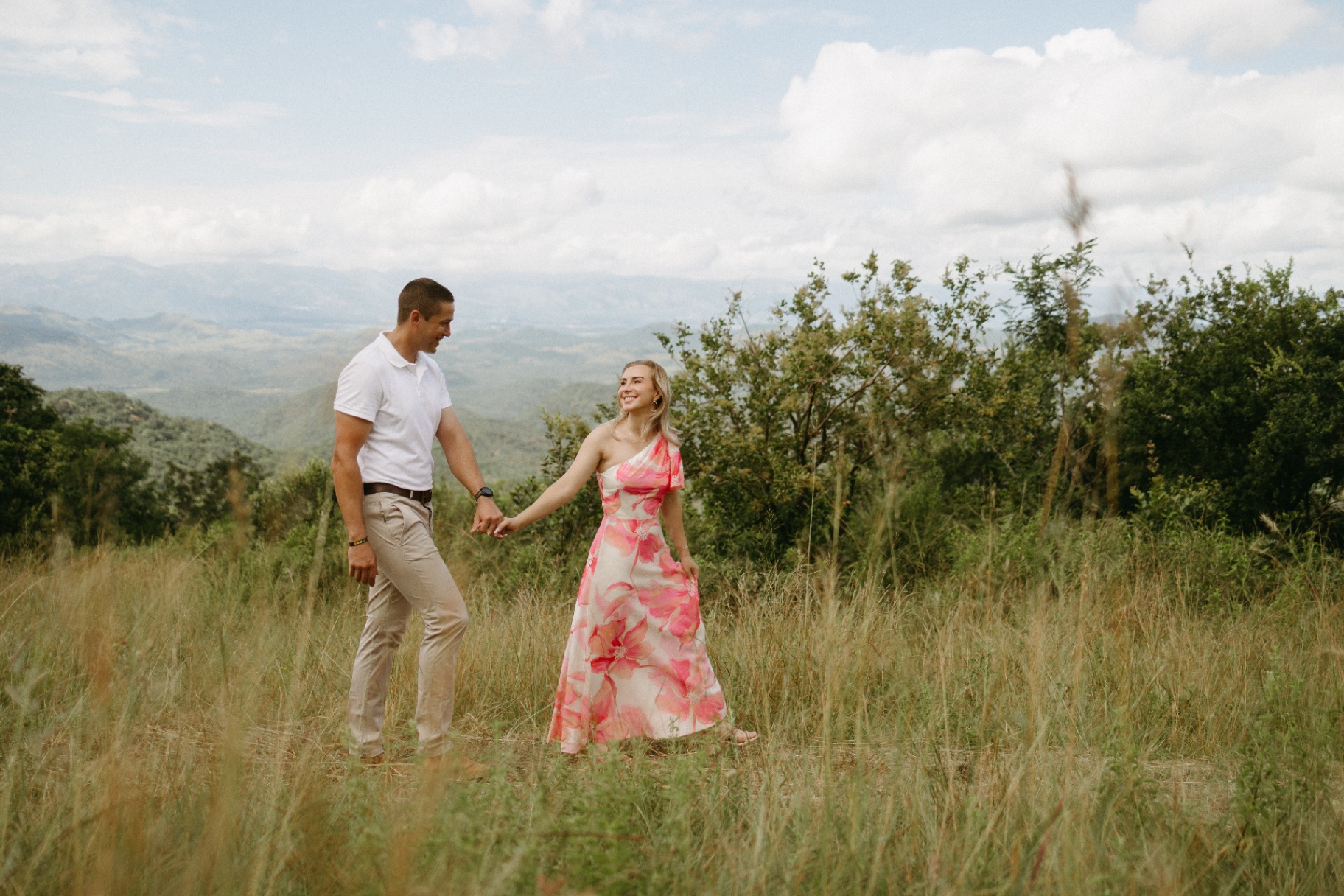 A couple walking hand-in-hand into the Lowveld toward the mountains