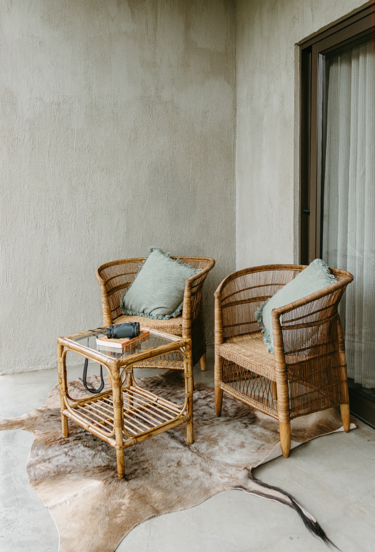 Wicker chairs on cowhide rug