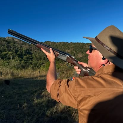 Golden-hour shooter mounting the gun on a Gold Valley stand