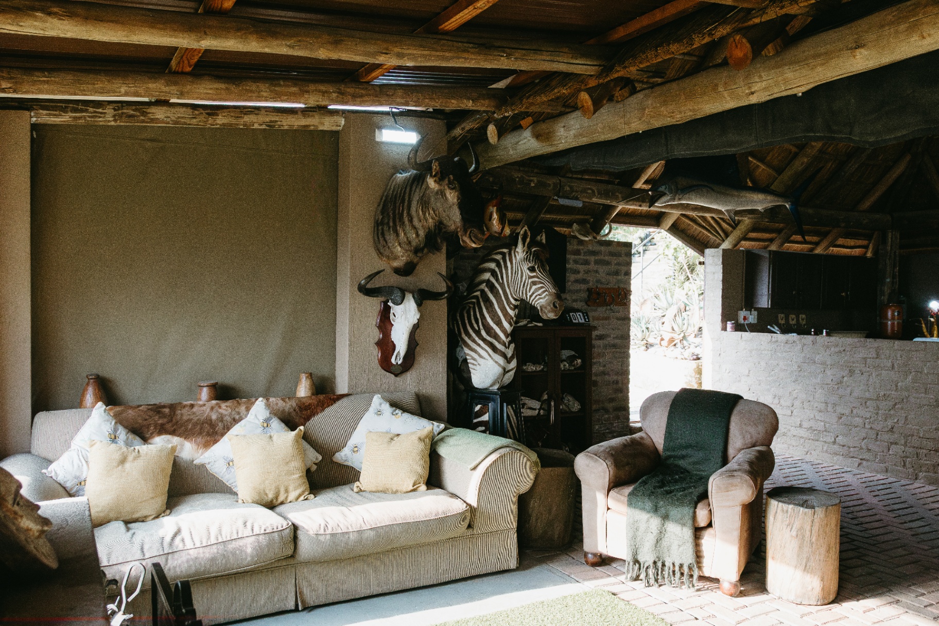 Outdoor safari lounge with mounted trophies