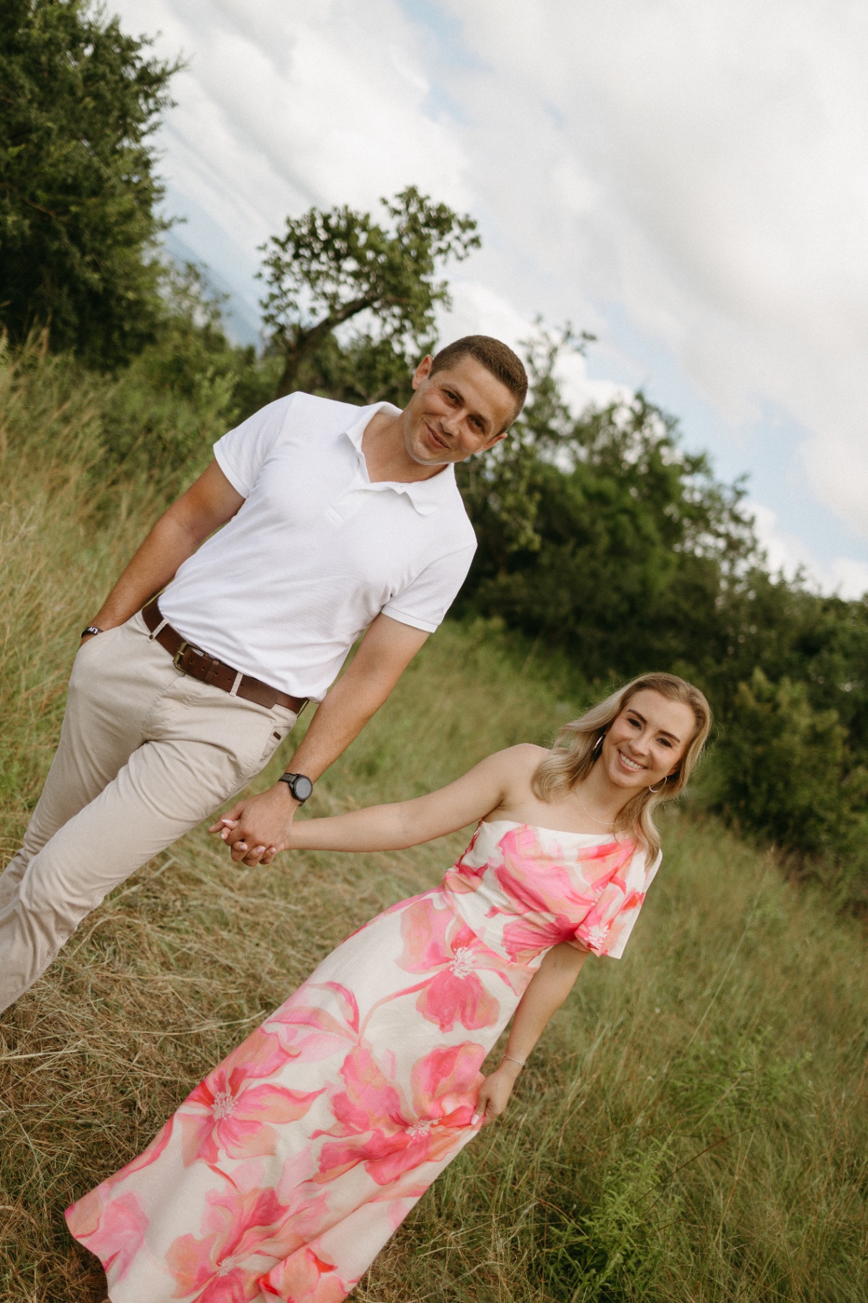 Couple walking toward the camera in a floral dress