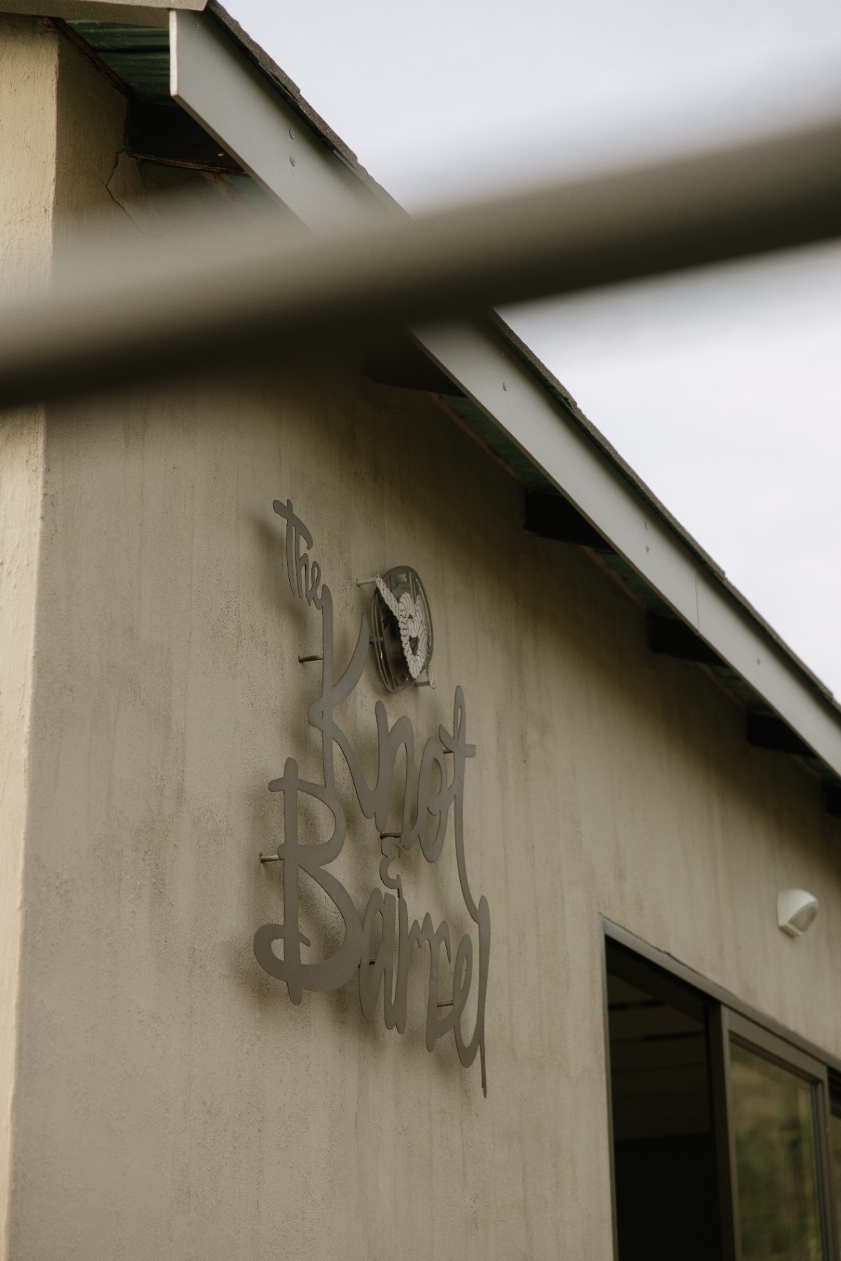 The Knot & Barrel sign mounted on the venue wall