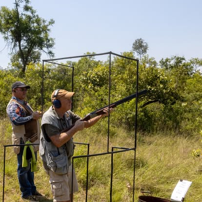 Two shooters on a stand overlooking the Lowveld mountains
