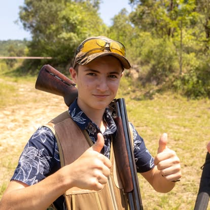 Junior shooter giving a thumbs-up between stands at Gold Valley