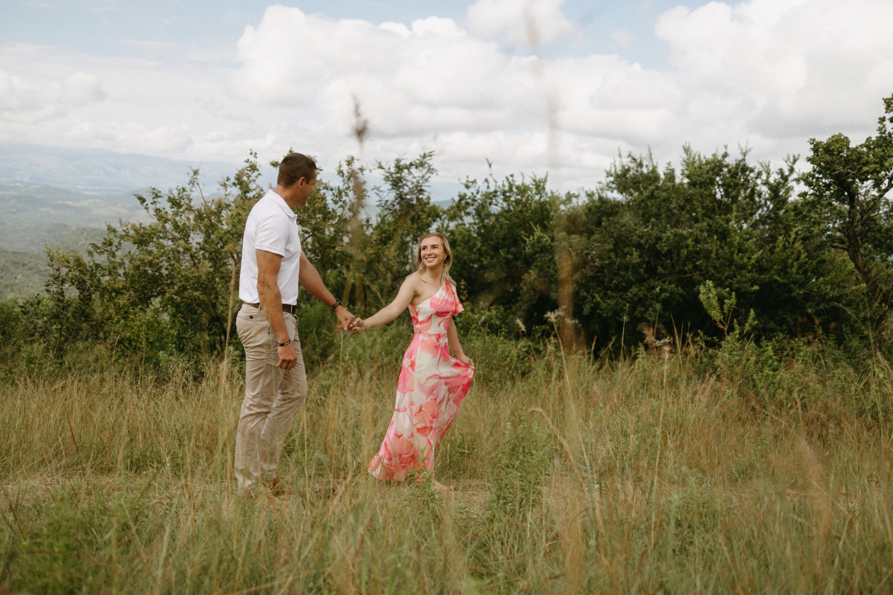 Couple holding hands with the Lowveld valley behind them