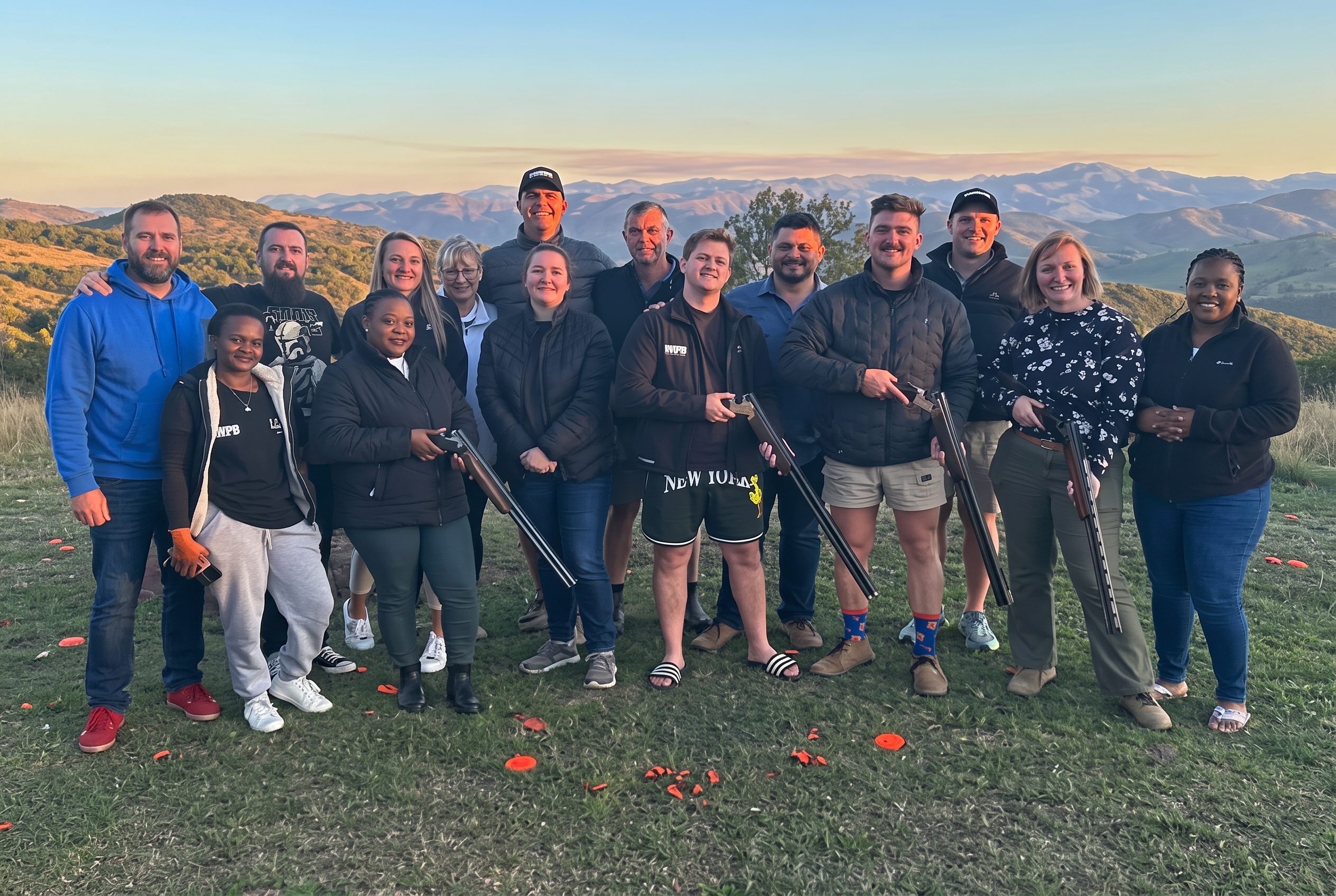 Members gathered at sunset with shotguns after a fixture