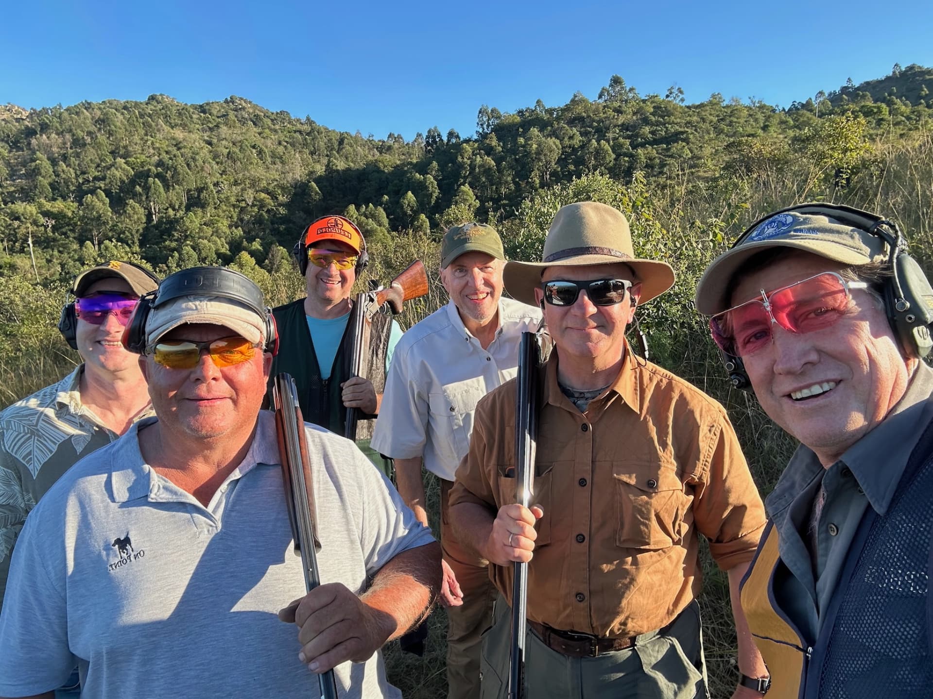 Six club members together in golden light on the range