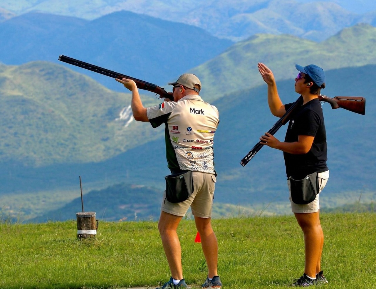 Two shooters on the stand at Gold Valley Gun Club with the Lowveld mountains behind